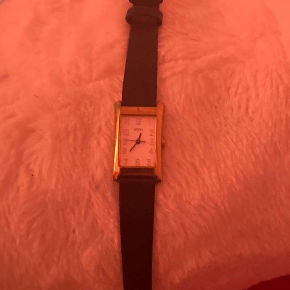 Guess watch says Guess in the face of watch